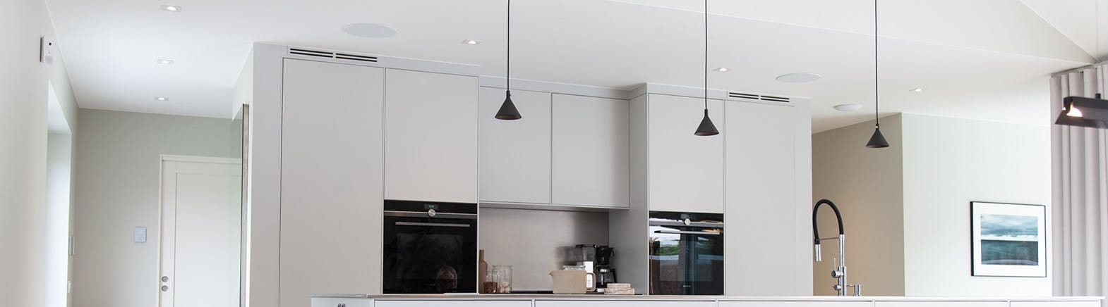 Light gray kitchen illuminated with Bright Eye Square I from Hidealite at home at Johanna Haglund, Design of.